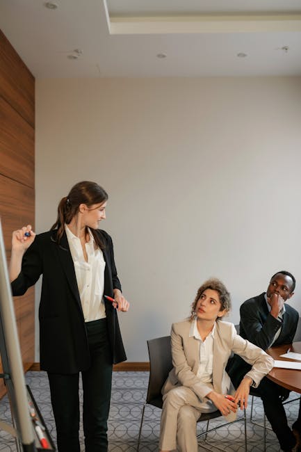 A Woman in Black Blazer Talking to Her Colleagues